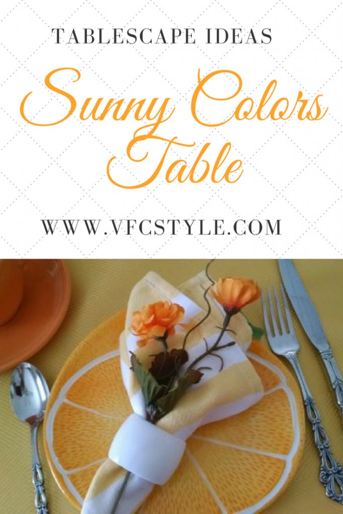 Who says yellow and orange are 'too loud' together? Find out with this pretty tablescape at Vintage Floral Cottage, featuring orange-slice plates from Pier 1! #tablescapeideas #orangeandyellow #tablescape #pier1orangeplates #oneidachandelier #sunnytablescape #prettytablesetting